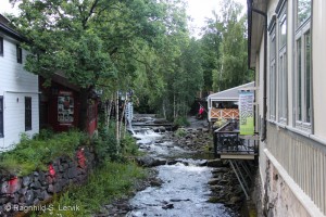 The outside seating of Nikkers restaurant at right, Blåmann just visible on the left by the waterfall.